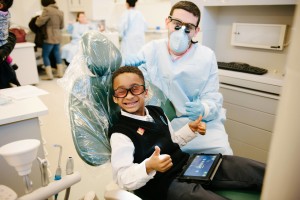 Kid smiling in dentist's chair