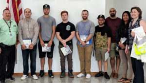 Professor Orla LoPiccolo (far right) with building manager Ron Goodwin (far left) and students