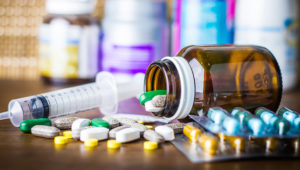 medications on a table and a syringe