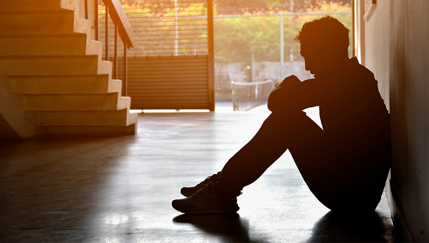 depressed student sitting alone