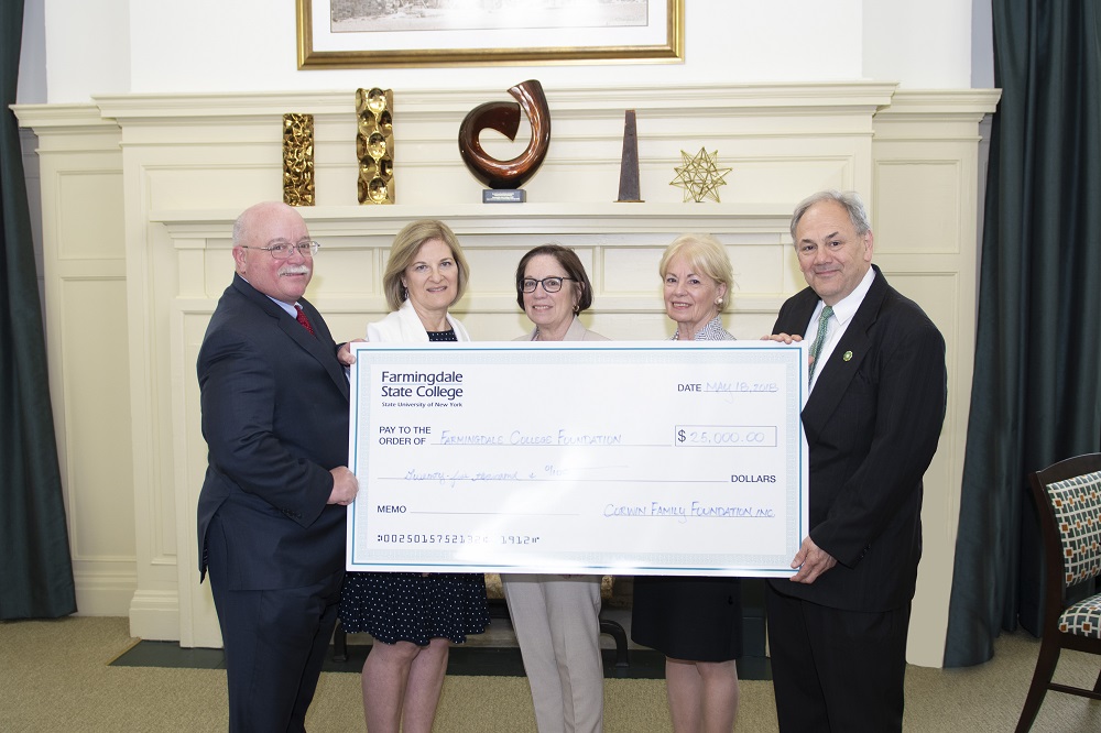 Corwin family holding a large check