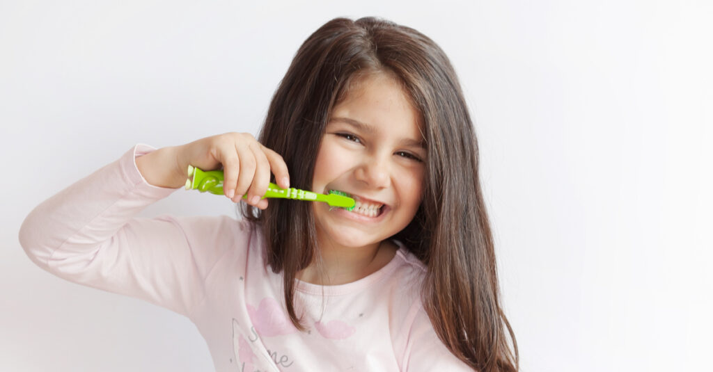 girl brushing her teeth