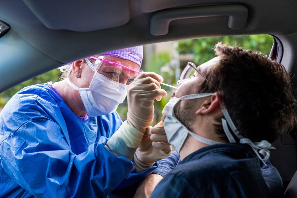 nurse administering nasal exam