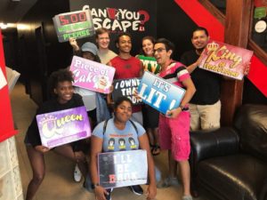 Students with colorful signs taking a group photo.