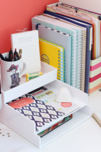 Corner desk area with notebooks and office utensils. 